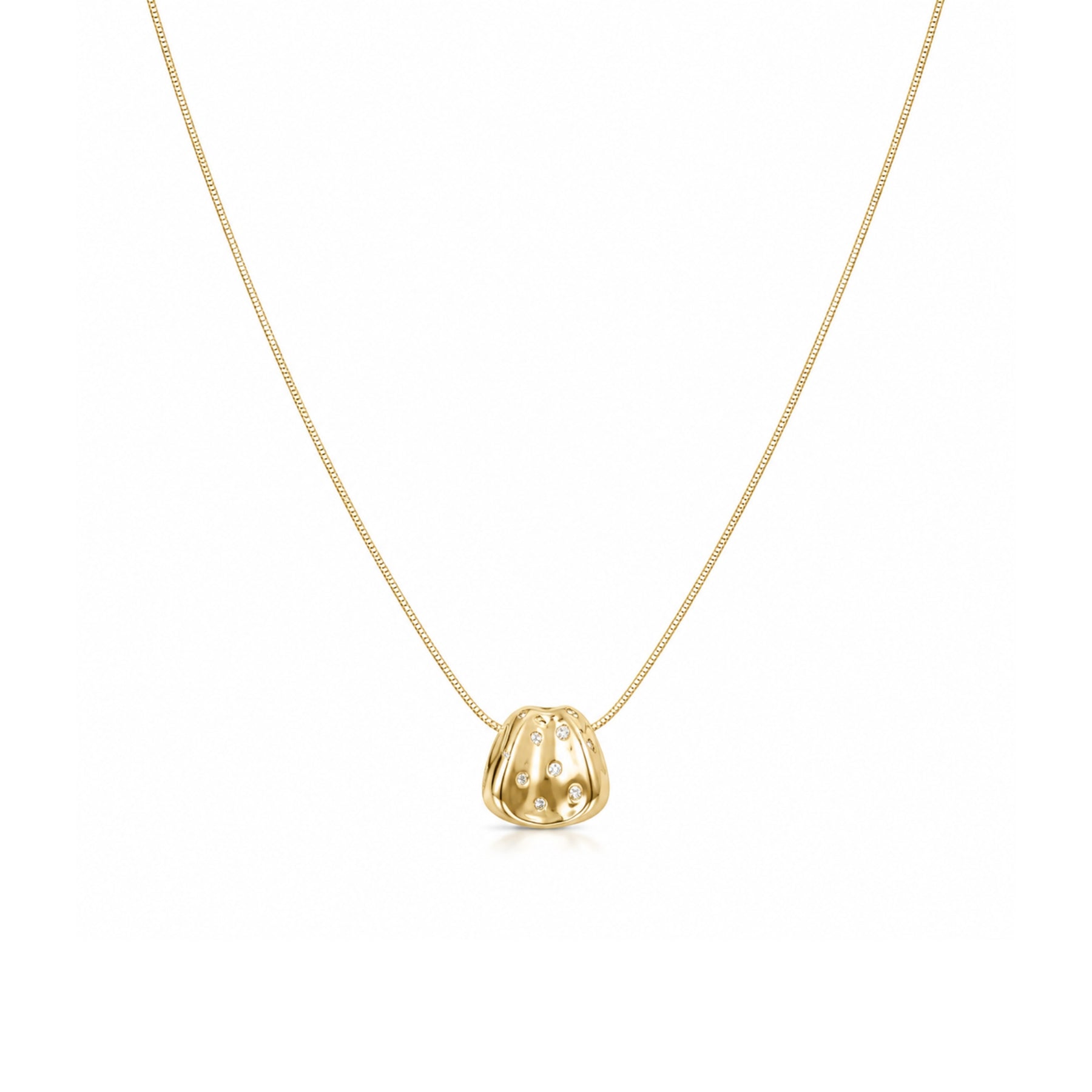 Gold-tone organic pendant necklace with clear stone accents on a white background