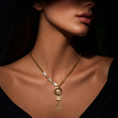 Woman wearing a gold-tone pearl-accent leaf drop necklace