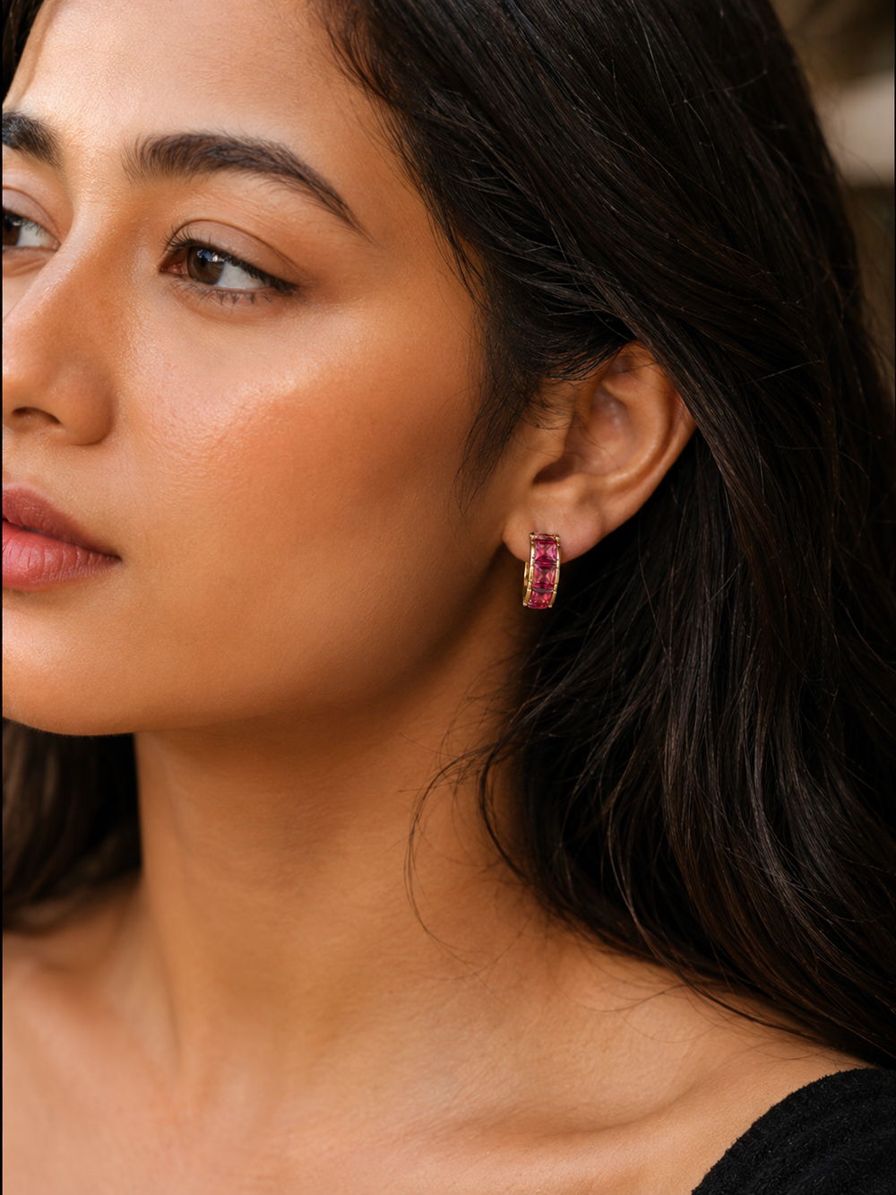 Luxury ruby pink crystal hoop earrings with gold plated finish on white background