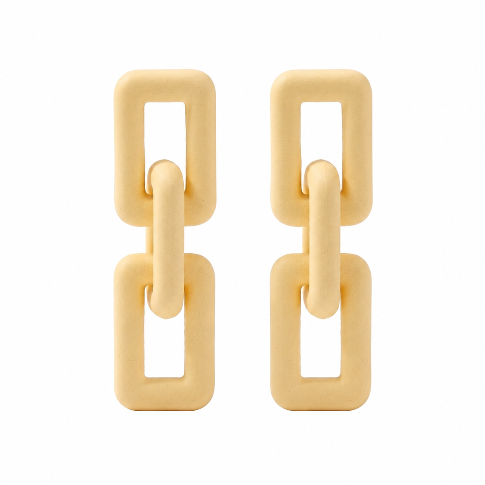 Woman wearing ivory geometric link statement earrings with modern matte finish and Korean-inspired minimal luxury design