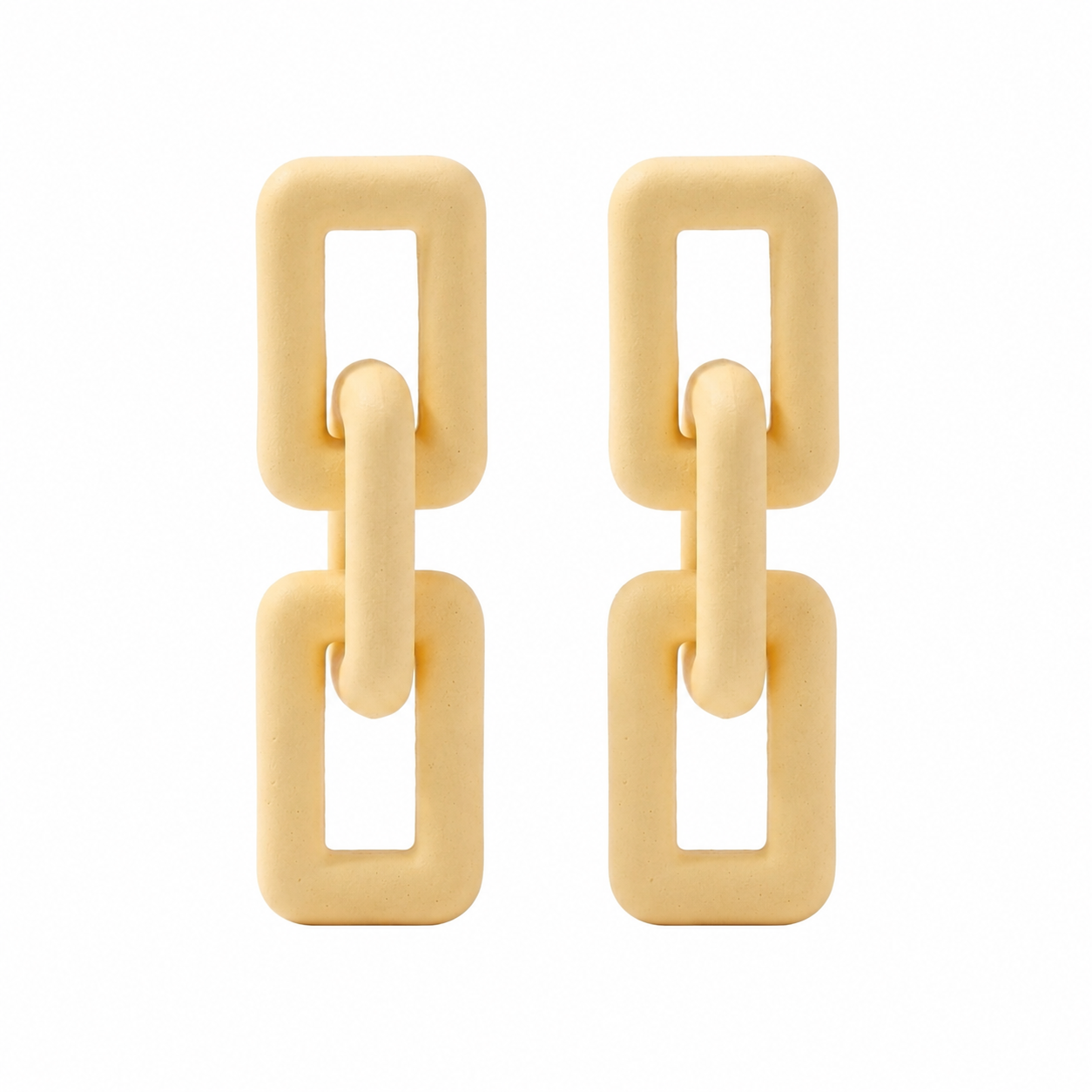 Woman wearing ivory geometric link statement earrings with modern matte finish and Korean-inspired minimal luxury design