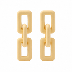 Woman wearing ivory geometric link statement earrings with modern matte finish and Korean-inspired minimal luxury design