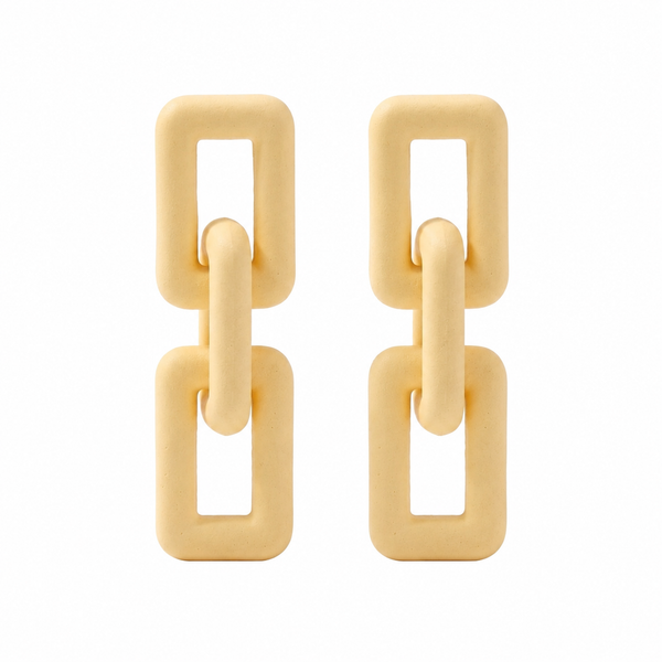 Woman wearing ivory geometric link statement earrings with modern matte finish and Korean-inspired minimal luxury design