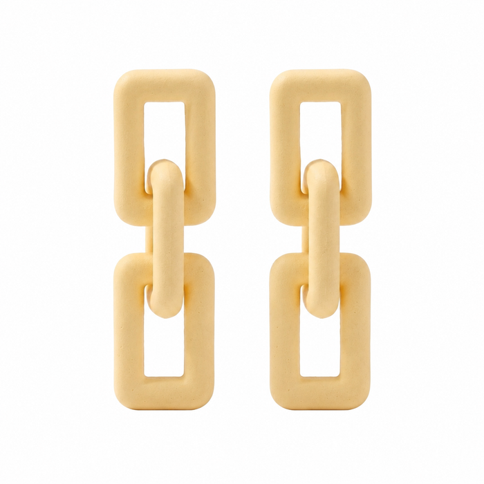 Woman wearing ivory geometric link statement earrings with modern matte finish and Korean-inspired minimal luxury design